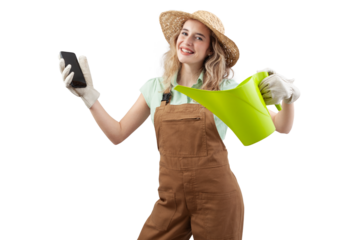 Smiling woman wearing an apron, hat and gloves for gardening holding a watering can, isolated on a white background showing smartphone. Online gardening shopping for spring and garden work