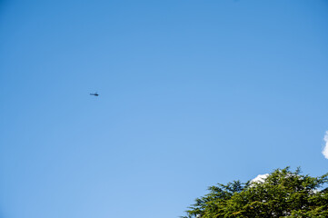 Small helicopter on a blue sky background.