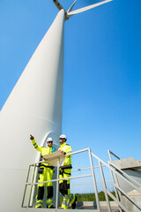 Team of electrical engineer is perform the inspection and maintenance of electric generating windmill turbine.