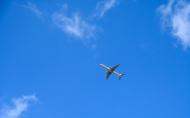 Airplane in the sky. Air travel. Jet passenger plane in blue sky.