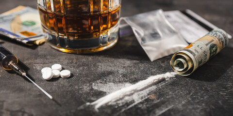 White drugs, narcotic pills, an alcoholic drink in a glass, a syringe with a dose of heroin, a line...