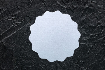 Coaster mockup. Overhead flat lay shot of a paper beermat, a template for design presentation on a black slate background