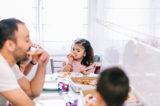 Family eating pizza during lunch