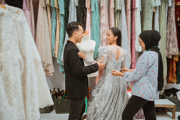 Participating in a fitting session with skilled designers at a lively dress studio