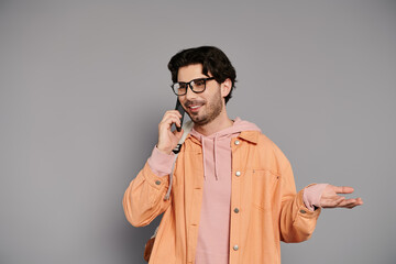 Young man enjoying a lively phone conversation with a bright smile in a modern setting