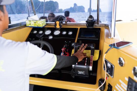 Captain driving speedboat in thailand with tourists on board
