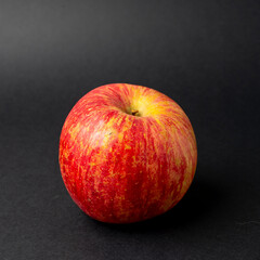 red apple on black background