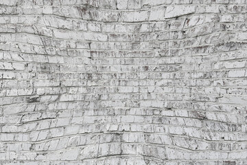 Old wall made of red brick, painted white in loft style