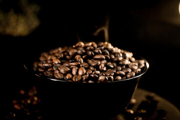 Close-up view of fresh coffee beans on a black background highlighting rich textures and details