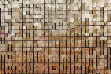 shiny, glittering yellow wall of small metal squares for photo zone, abstract background, copy space, texture, pattern