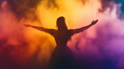 Celebrate Holi with vibrant visuals featuring a dancing silhouette surrounded by colorful powder clouds.

