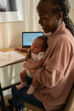 Woman working from home and babysitting 