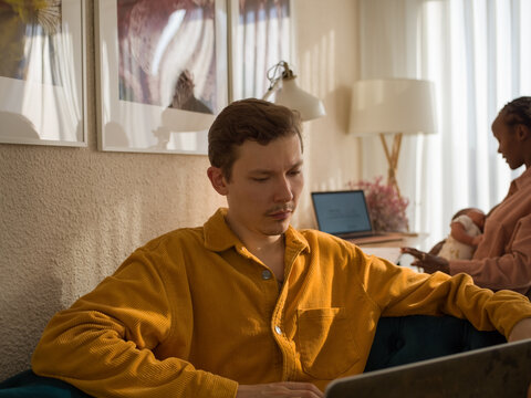 Multiracial freelancers with baby at home
