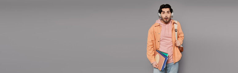 Young man with stylish outfit showcasing confidence in a modern urban setting