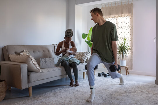 Man doing sports and watching his wife and child