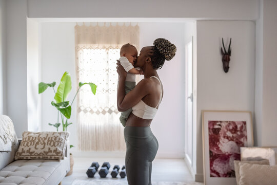 Mother lulling baby at home