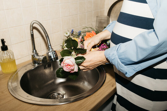 Pregnant woman processing flowers in her home