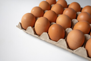 Chicken eggs in a paper tray side view close up