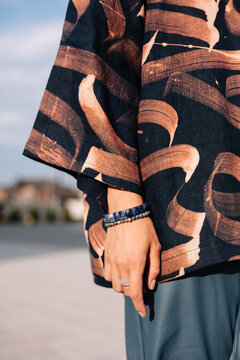 Elegant hand detail showcasing artistic fabric with abstract pattern