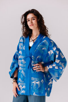 A model showcases a stylish blue kimono with a unique pattern