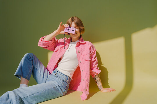 Woman photographing with single use film camera 