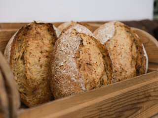 textured round bread on a wooden shelf