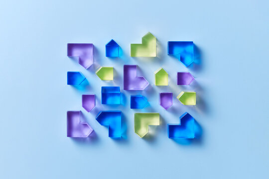 Arrangement of glass geometric pieces of blue, purple and green color