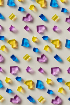 Seamless pattern of colorful glass shapes on beige background
