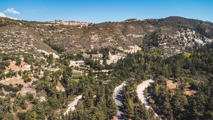 Obraz premium Aerial view of a green valley with winding roads in Tala, Paphos, Cyprus