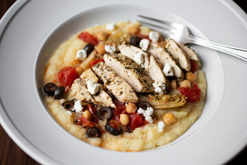 Italian Chicken and Polenta Dinner Dish with tomatoes, chickpeas, olives and goat cheese