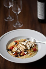 Italian Chicken and Polenta Dinner Dish with tomatoes, chickpeas, olives and goat cheese