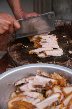 Closeup of the pork belly being sliced