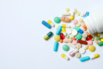 Various pills on white background