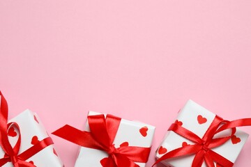 Beautiful gift boxes with red hearts and paper card on color background