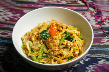 point of view of fried noodles with egg, Thai food. Top view of traditional tablecloth