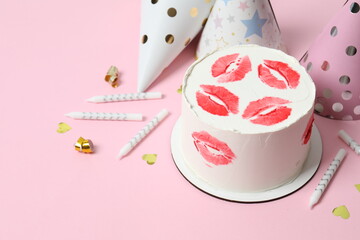 Colorful cake decorated with red lips on color background