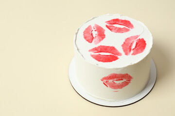 Colorful cake decorated with red lips on color background