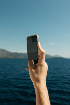 man taking photo of the sea