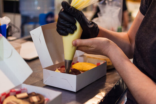 Worker finishing up cookie orders