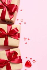 Beautiful gift boxes with red hearts and paper card on color background