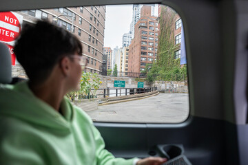 Tourist observing new york city streets from a car window