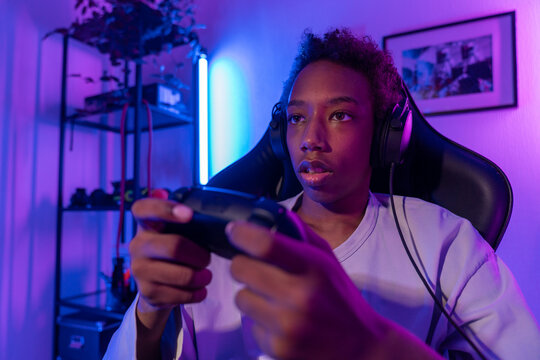 Focused Teen Playing Video Game with Controller
