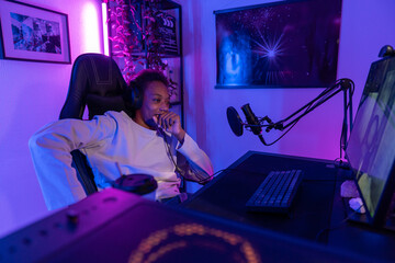  Young Man Streaming and Relaxing in Gaming Setup with Microphone