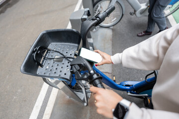 Woman using smartphone to rent a bike in new york city