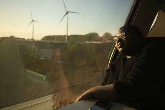 Tranquil journey beside windmills at sunset