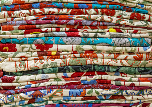 Background of colorful stacked woven fabric