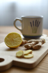 Vertical photo of mug ginger and lemon on wooden table