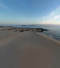 Aerial view of golden sand beach with waves crashing. Taken in Fuerteventura. 