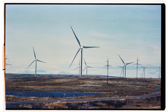 Wind turbines on a landscape during clear weather in rural area