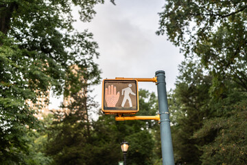 Pedestrian crossing signal showing red hand in central park, new